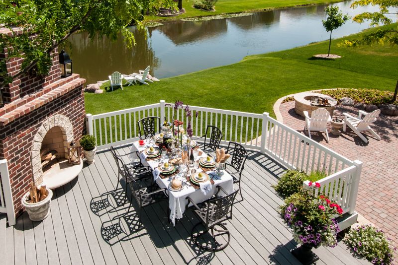 composite deck with a fire place and a dinning area
