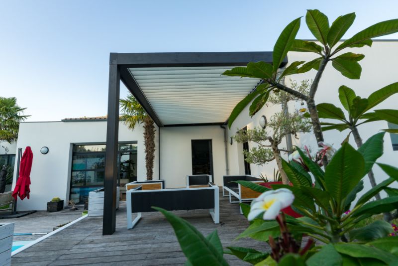 black roof pergola next to a pool