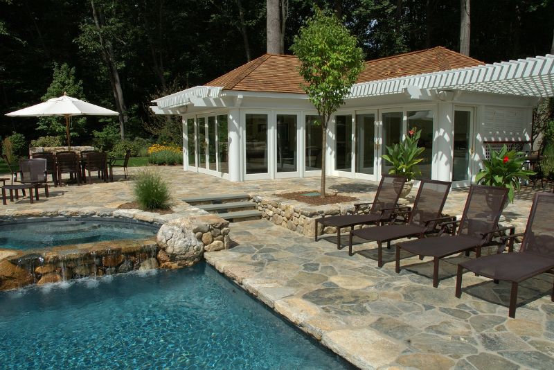 pool deck with four pool lounge chairs
