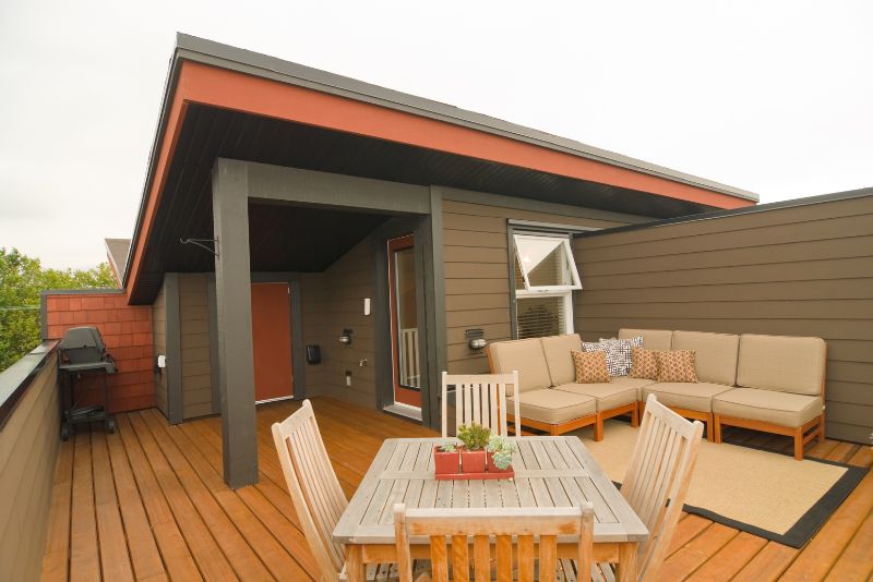 timber deck with outdoor couch and dinning area